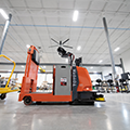 Autonomous_warehouse_vehicles_Toyota_Tugger_side_view_tugging_cart_AGV