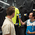 Decathlon microfulfillment case study -  retail worker showing customer mobile microfulfillment system
