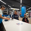 Decathlon customer picking up item from microfulfillment counter