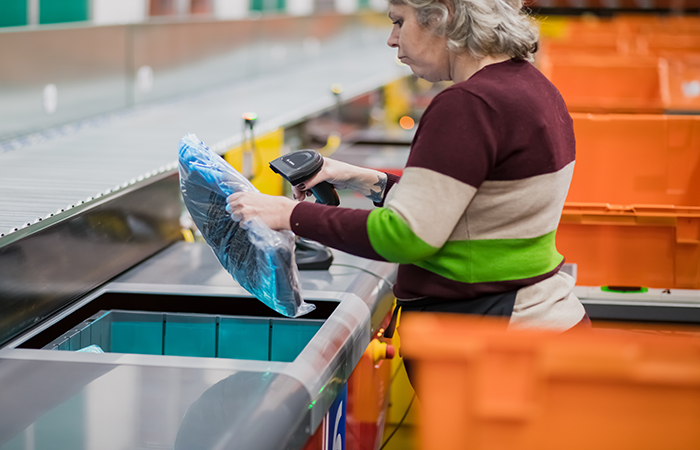 woman at AutoStore workstation order fulfillment